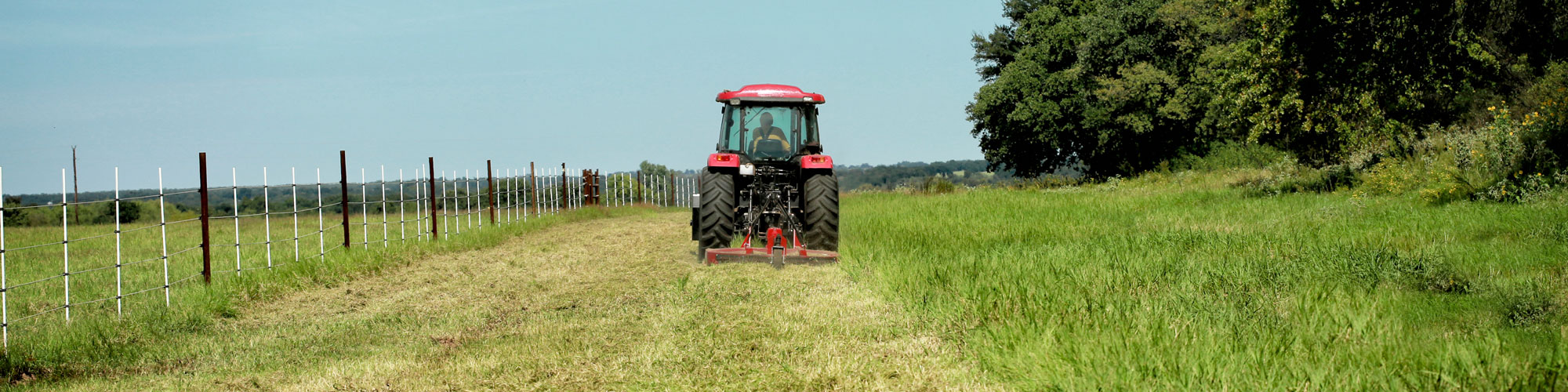 Farming: Large Red Tractor Moving Green Farmers Pasture